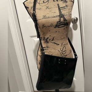 Kate Spade Darby Metro black crossbody with perferrated black heart design.